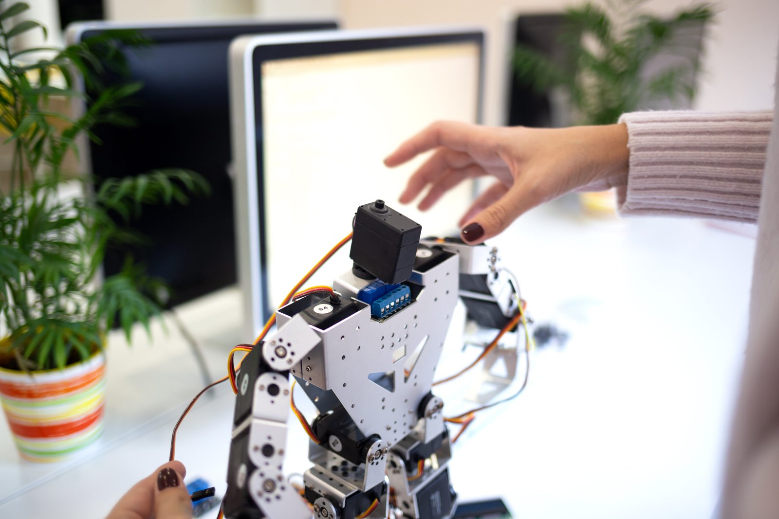 shooting close-up. woman designs a large modern robot.